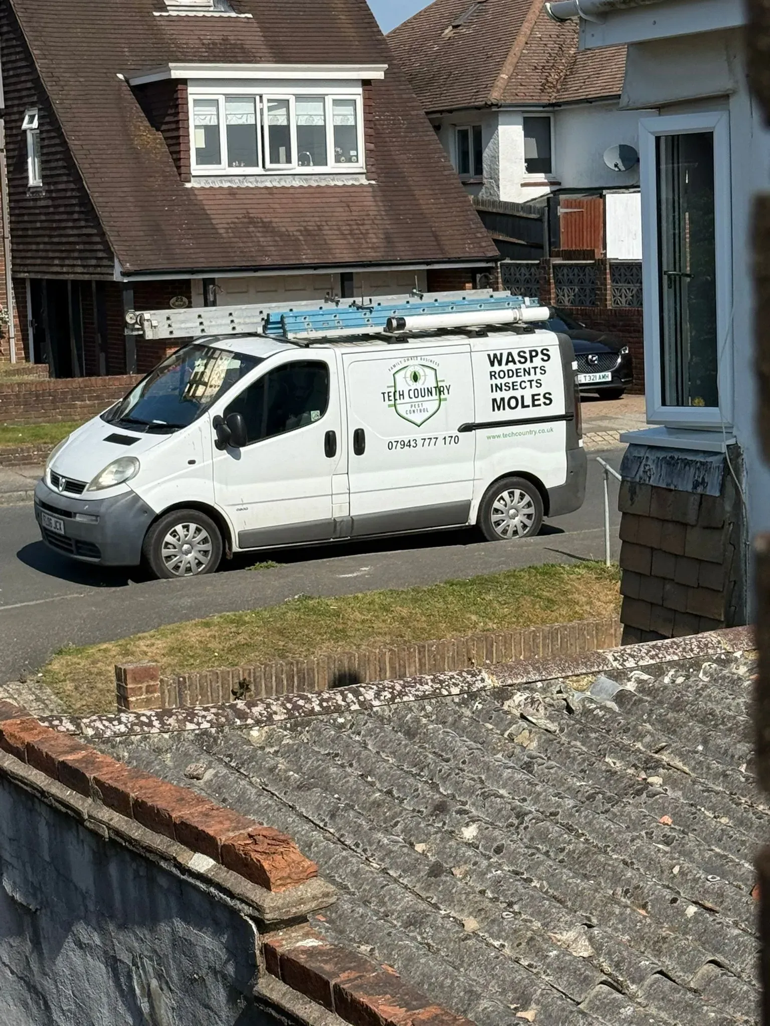 Tech Country Pest Control van parked on a residential street, ready for pest control services.
