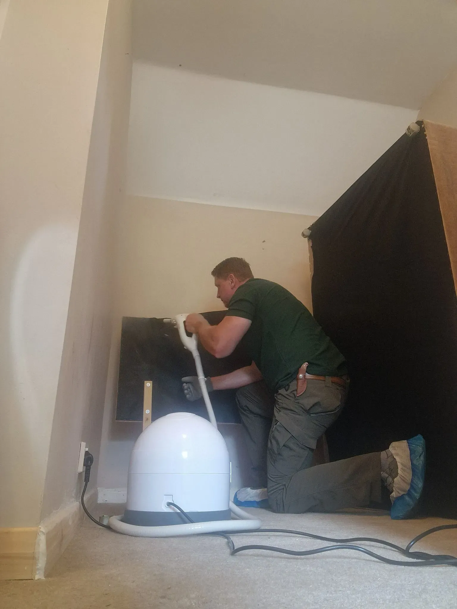 Pest control technician using a steam cleaner to eradicate bed bugs or other insects, demonstrating thorough and safe treatment.
